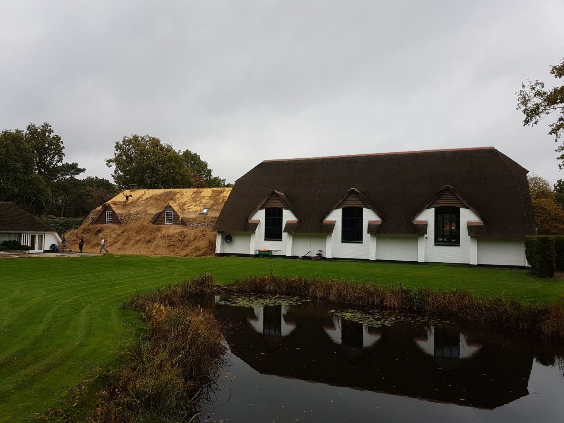 Wit huis met afgevoerde stapel riet
